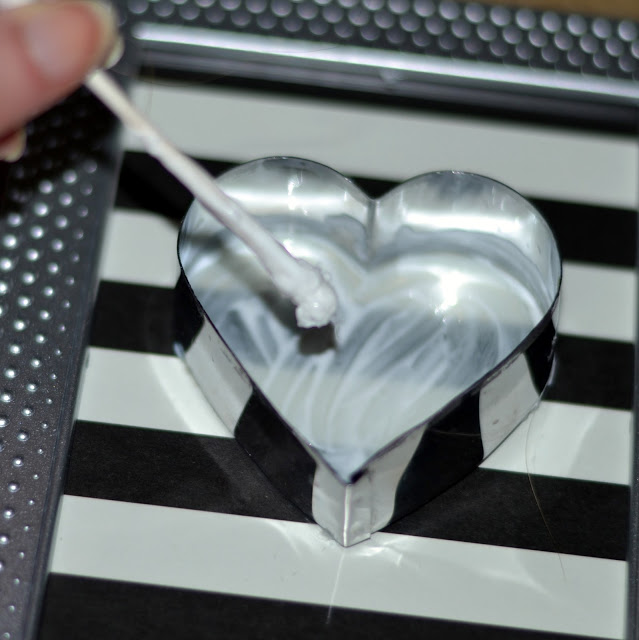 using a cookie cutter as a guide to create a Valentine's day button art glue in cookie cutter